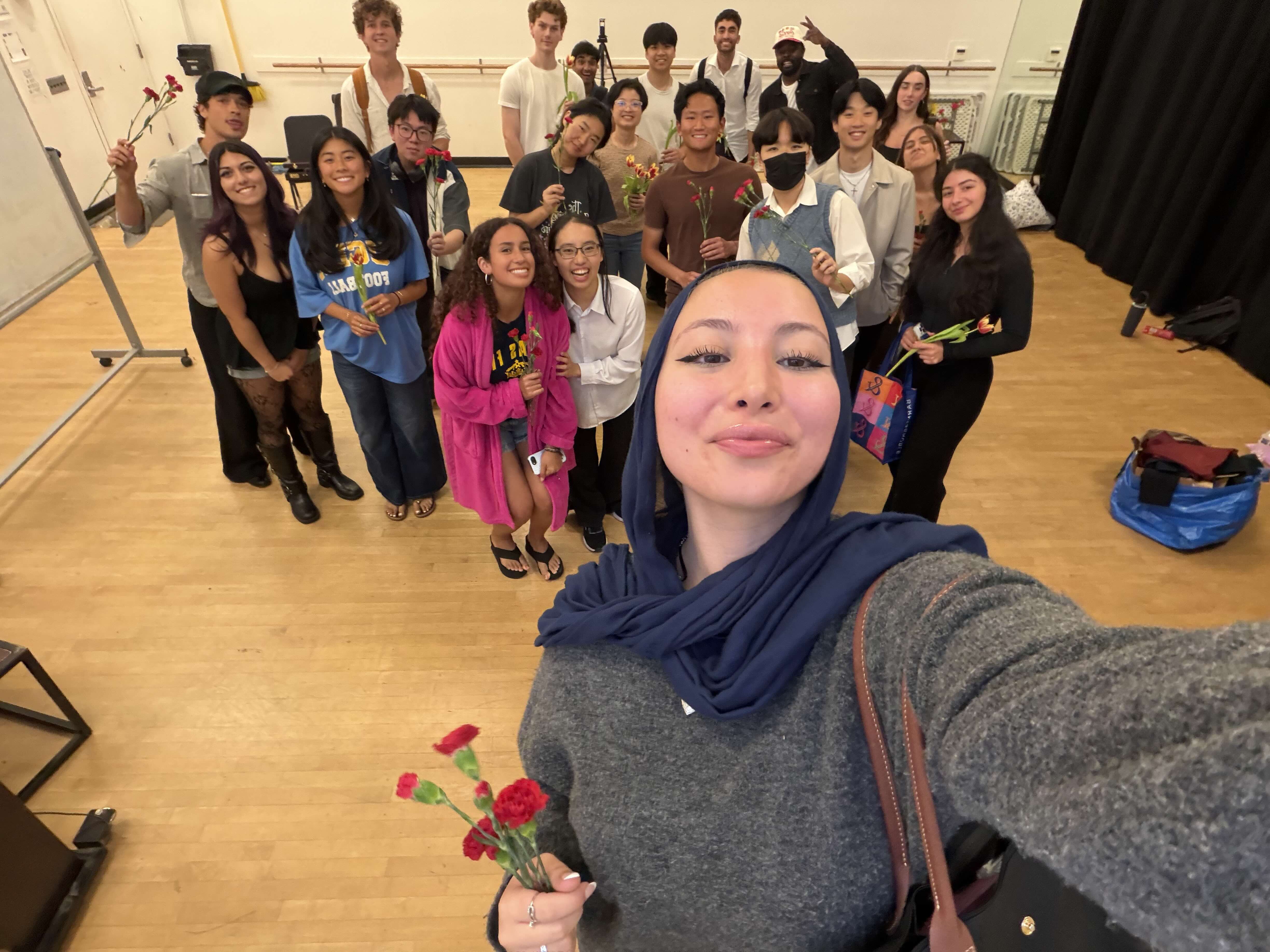 The acting class posing together with flowers
